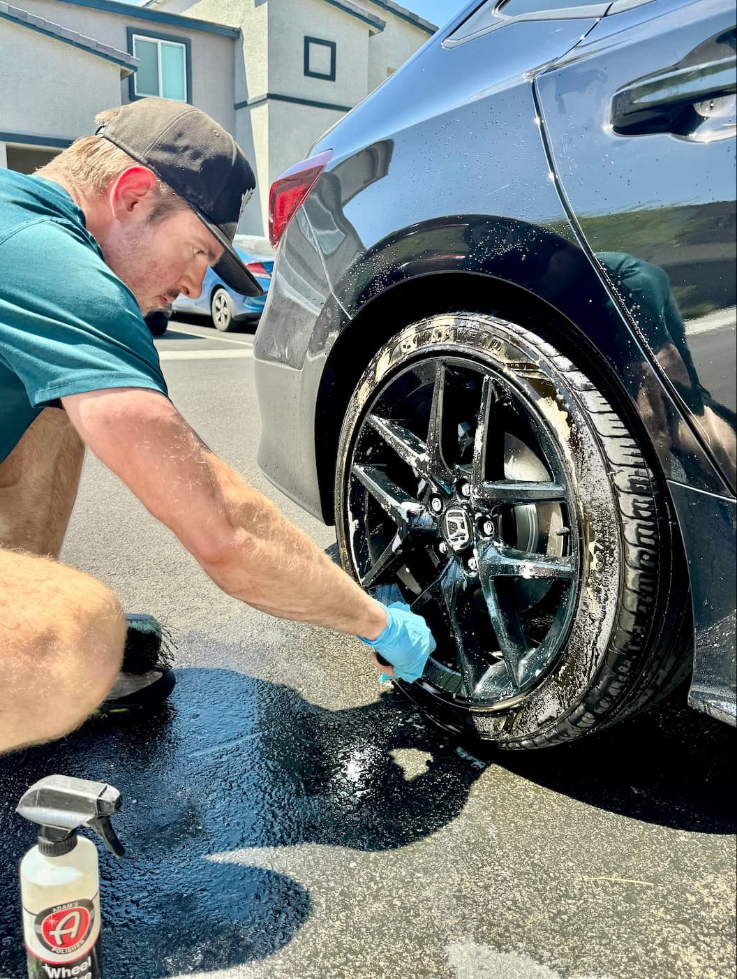 Jake cleaning wheel with Adam's bottle